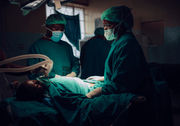 Doctors taking care of a patient during operation